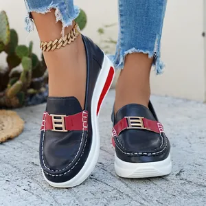Stylish navy blue platform loafers with red accents and gold buckle