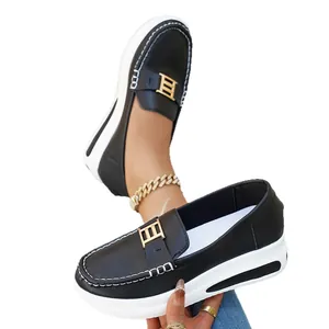 Stylish women's black platform loafers featuring gold buckle detail and white thick soles