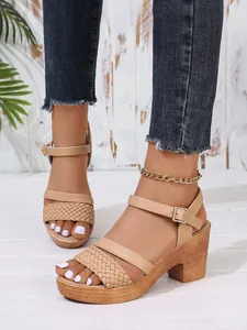 Close-up view of beige platform chunky heel sandals with braided front strap and buckle