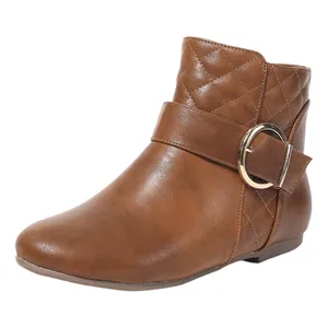 Detailed view of brown faux leather Chelsea boot featuring quilted texture and large gold buckle
