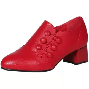 Vintage red pointed toe pumps featuring chunky mid heels and elegant button accents
