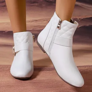 Elegant white quilted Chelsea boots featuring a side zipper and stylish buckle detail