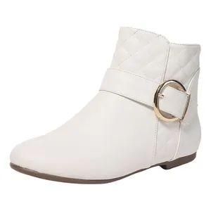 Close-up of white Chelsea boot with a large gold buckle and elegant quilted pattern