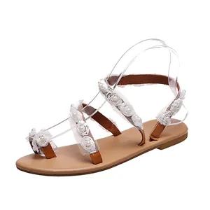 Side profile of Bohemian flat sandals with white lace flowers and pearl embellishments