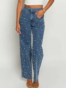 Detailed view of vintage Y2K baggy jeans with cross waist and white pearl beads