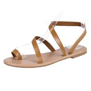 Side view of elegant tan strappy flat Roman sandals with a Bohemian summer design