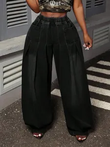 Detailed view of high-waist elastic band and pleated design on black lantern jeans