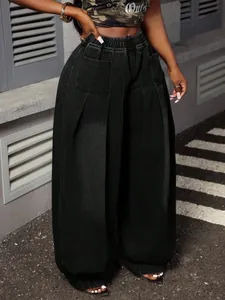 Detail view of high-waist pleated wide-leg lantern jeans in black washed denim