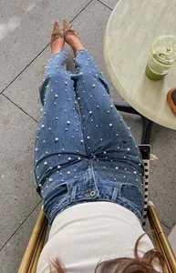 Detail shot of Y2K vintage baggy straight-leg denim jeans with pearl stud embellishments