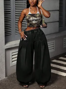 Detail view of vintage washed black pleated wide-leg denim lantern pants.