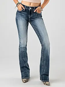 Detail of high-waisted stretch flared jeans featuring heavy contrast white stitching