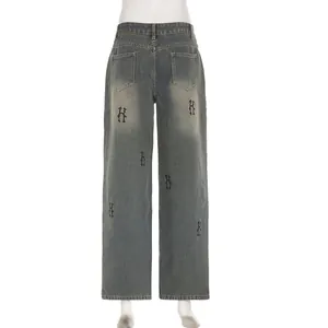 Vista dettagliata dei jeans denim lavati vintage con stampa di lettere gotiche sul retro