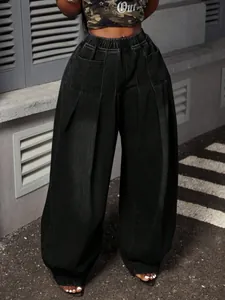 Close-up of vintage black washed wide-leg denim lantern pants with pleated details