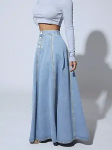 Detailed side view of light blue denim A-line maxi skirt featuring button details.