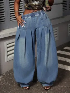 Close-up detail of vintage washed blue high waist pleated balloon denim pants for women