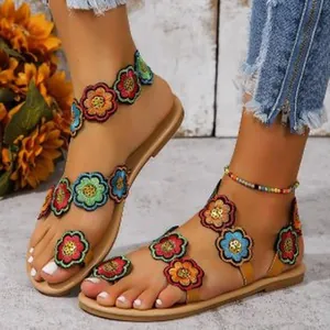 Bohemian style flat sandals featuring vibrant colorful embroidered flowers and ankle strap