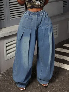 Close-up detail of vintage washed blue pleated wide-leg lantern jeans with high elastic waist