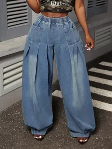 Close-up of vintage washed blue pleated wide-leg lantern jeans with elastic high waist.