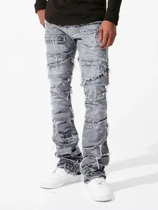 Detailed shot of grey men's streetwear denim pants with distressed patchwork design