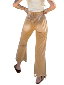 Rear view of women's high-waisted tan flared jeans with frayed raw hem details.