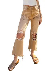 Detailed view of women's straight loose ripped jeans in tan brown with frayed hem