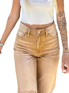 Detailed view of high-waisted vintage tan straight-leg jeans with distressed edges.