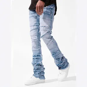 Men's light blue distressed patchwork stacked jeans featuring a street fashion design