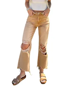 Close-up view of women's khaki ripped straight leg denim jeans with frayed hems.