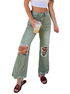 Detail view showing distressed knee holes on olive green ripped straight-leg denim jeans