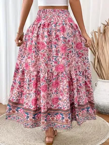 Detail view of pink floral maxi skirt featuring a smocked high waist and tiered hem.