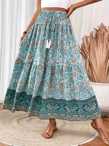 Detailed view of a bohemian blue floral maxi skirt with drawstring tassel waist details