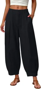 Detail view of women's loose black cropped harem pants with stylish elastic waist