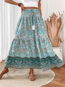 Detailed view of bohemian floral maxi skirt featuring smocked waist and tassel drawstring.
