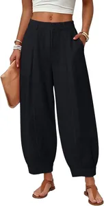 Front view of black loose-fit cotton harem pants with side pockets and high waist.
