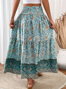 Bohemian floral print maxi skirt with high shirred waist and tiered hem detail.