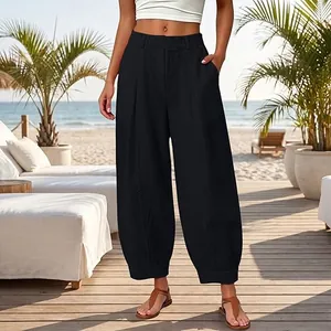 Professional lifestyle view of women's black cropped harem pants at a beach resort