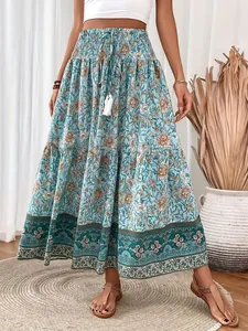 Detail view of a bohemian floral maxi skirt with smocked waist and tassel drawstring.