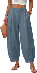 Full view of women's loose high-waisted harem pants in dusty blue linen fabric