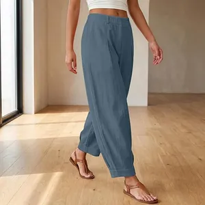 Detail of blue loose-fit cropped harem pants with stylish elastic waist design.