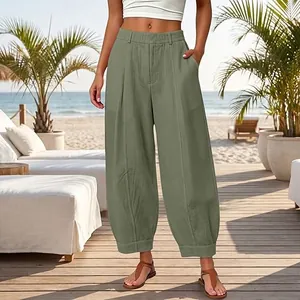 Stylish high-waisted loose harem pants in sage green featuring elegant pleated front details