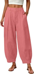 Detailed view of pink loose cropped harem pants with elastic waist and side pockets