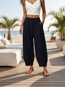 Stylish black loose harem pants with a high waist for a slimming summer beach look.