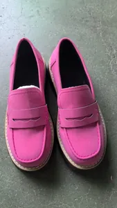 Overhead view of bright pink suede loafers with classic British style strap detail
