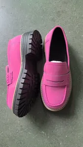 Detailed view of vibrant pink nubuck loafers featuring thick black lug soles and stitching