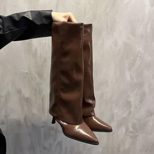 Detail view of brown pointed-toe fashion boots with unique fold-over shaft design.