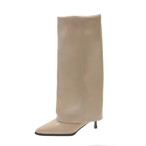 Side profile of elegant beige pointed-toe boots with a stylish folded wide shaft.