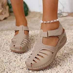 Close-up of beige vintage Roman sandals featuring wedge heel and stitching detail