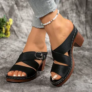 Elegant women's black chunky heel sandals with floral cut-out patterns and buckle strap