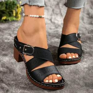 Elegant black laser-cut chunky heel sandals with metal buckle strap detail for summer