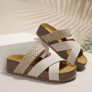 Detailed view of women's cream platform sandals with cross-strap and braided texture design.